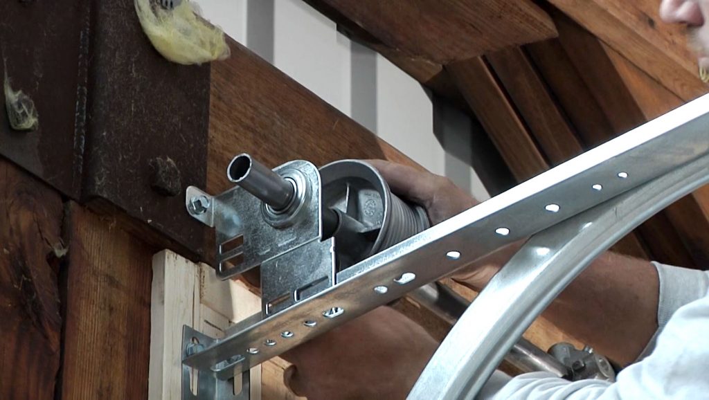 Installing the cone of a garage door image.